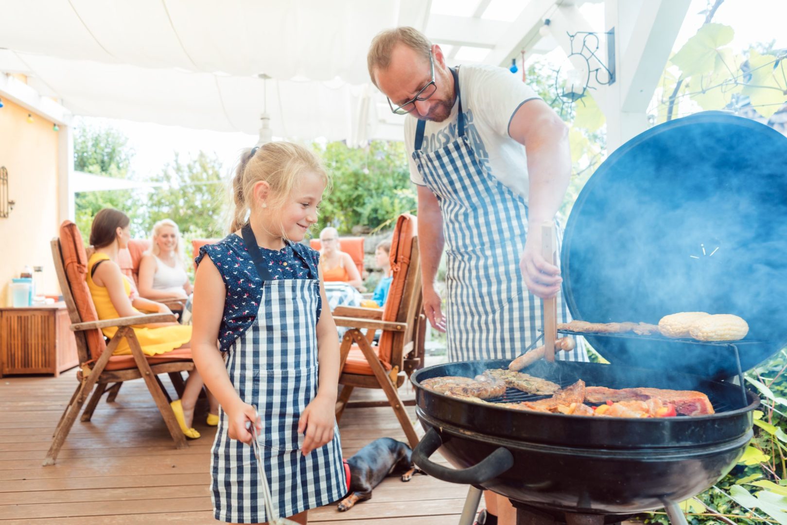 Dad grilling with daughter