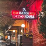 YO Ranch Steakhouse lit sign from the street view